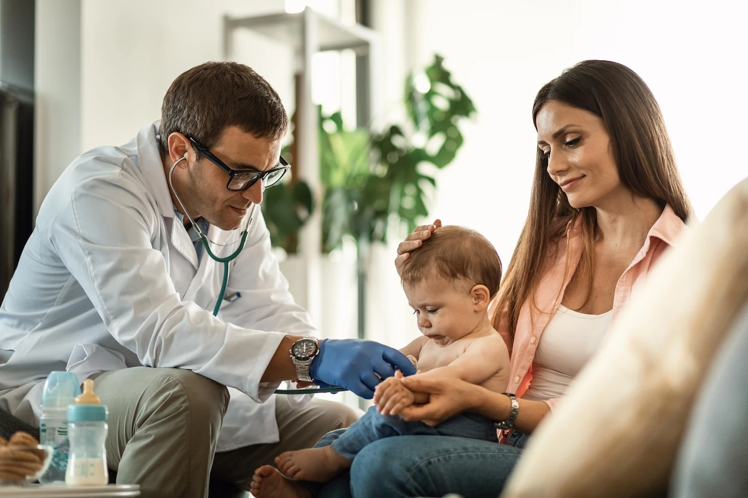 baby-boy-getting-medical-exam-by-doctor-while-bein